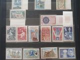 a display of stamps on display in a glass case
