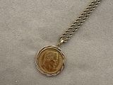 a close up of a coin on a chain on a table