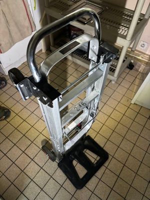 a hand truck that is sitting on a tiled floor