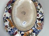 a plate with a floral design on it sitting on a table