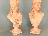 pair of white marble busts of a woman and a man