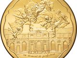 a close up of a gold coin with a statue on it