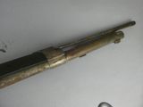 a very old gun that is laying on a table
