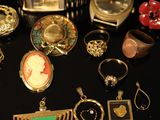 many different types of jewelry on a black surface