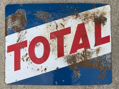 a sign that says total on the side of the road