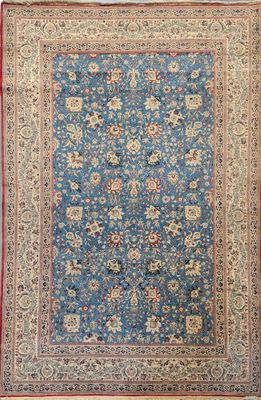 a blue rug with a red border and a floral design