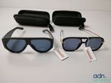two pairs of sunglasses and a case on a table