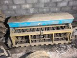 a blue bench sitting in the middle of a pile of tires