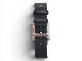 a close up of a black leather belt on a white surface