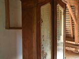 a large wooden cabinet in the middle of a room