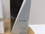 two boxes of unic products sitting on a wooden table