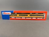 an orange and yellow train car in a box on a table