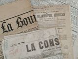 several old newspapers are stacked on top of each other