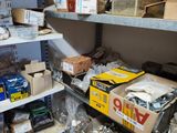 shelves filled with assorted items in a room with a lot of boxes