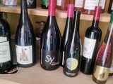 several bottles of wine are lined up on a shelf