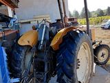 a tractor that is parked next to a building