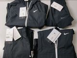 a group of men ' s nike tracksuits sitting on top of a table