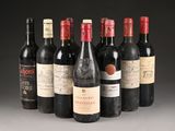 several bottles of wine are lined up in a row