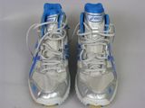 pair of silver and blue running shoes on a white surface