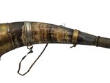 a large horn with a metal handle on a white background