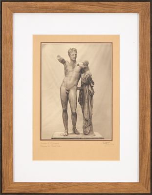 an old picture of a man holding a statue in a wooden frame