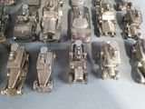 a lot of silver toy cars that are on a table