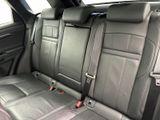 the back seats of a car are black and grey in color