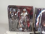sides of two boxed action figures of a woman with a sword in a box