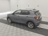 the rear end of a gray suv parked in a garage