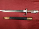 a close up of a knife and a bullet on a red cloth