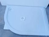a white toilet with a lid that is sitting on the ground