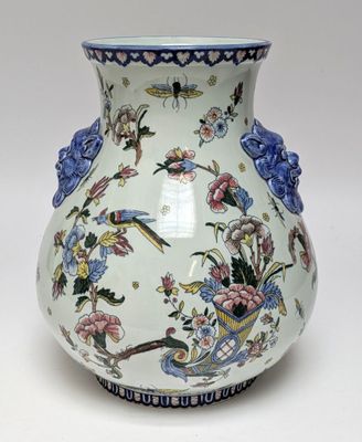 a white vase with blue and pink flowers on it