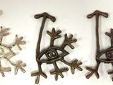several metal objects are displayed on a white surface