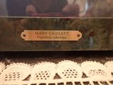 a close up of a glass case with a name plate on it