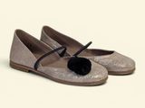silver glitter ballerinas with black pom pom on the toe