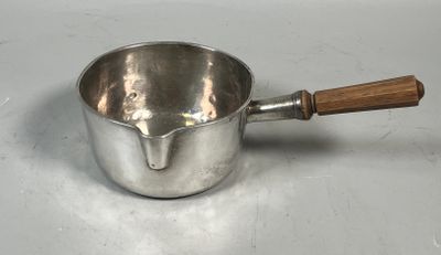a silver saucepan with a wooden handle on a table