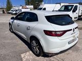 the rear end of a white car parked in a parking lot