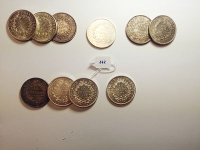 several different coins are arranged in a row on a table