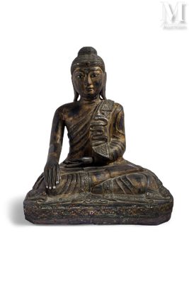 an image of a statue of a person sitting on a rock