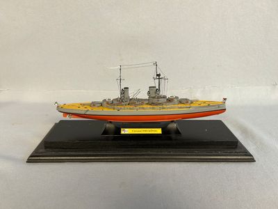a model of a small boat on a wooden stand
