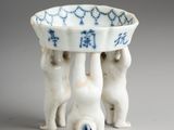 a small white bowl with blue designs on it