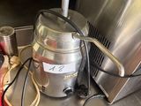 a silver machine sitting on a counter in a kitchen