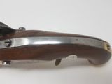 an old gun that is on a table with a white background