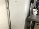 a white refrigerator in a kitchen next to a counter