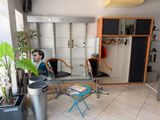 a man that is sitting in a chair in a room