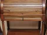 a small wooden desk with a glass top on it