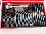 a red box with silverware in it on a table