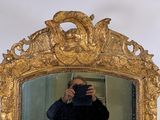 a man taking a picture of himself in the mirror
