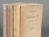 three books sitting on top of each other on a gray surface