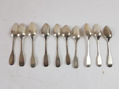 six spoons are lined up next to each other on a table
